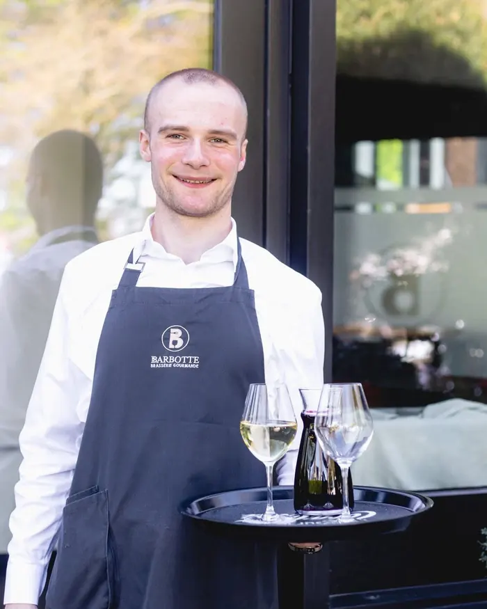 Membre de l’équipe présentant un plateau de vins